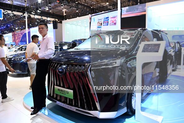 People look at various vehicles at the 23rd Autumn International Auto Show in Qingdao, China, on September 5, 2024. 