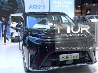 People look at various vehicles at the 23rd Autumn International Auto Show in Qingdao, China, on September 5, 2024. (