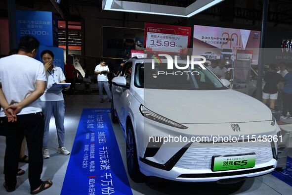 People look at various vehicles at the 23rd Autumn International Auto Show in Qingdao, China, on September 5, 2024. 