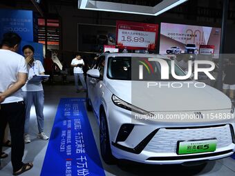 People look at various vehicles at the 23rd Autumn International Auto Show in Qingdao, China, on September 5, 2024. (