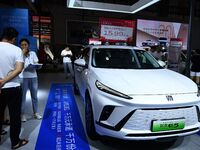 People look at various vehicles at the 23rd Autumn International Auto Show in Qingdao, China, on September 5, 2024. (