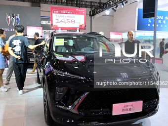 People look at various vehicles at the 23rd Autumn International Auto Show in Qingdao, China, on September 5, 2024. (