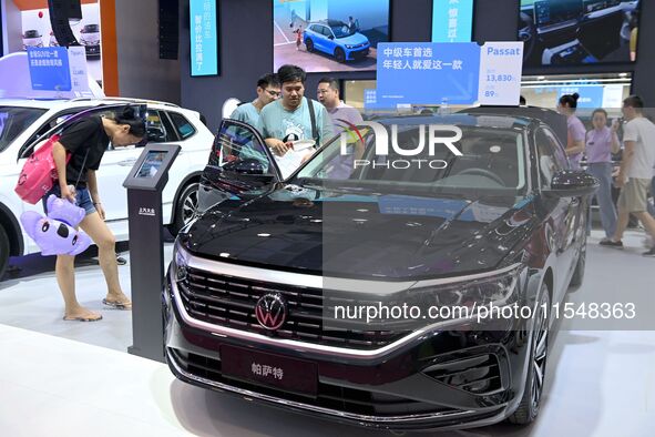 People look at various vehicles at the 23rd Autumn International Auto Show in Qingdao, China, on September 5, 2024. 