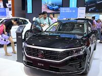 People look at various vehicles at the 23rd Autumn International Auto Show in Qingdao, China, on September 5, 2024. (