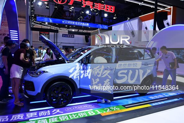 People look at various vehicles at the 23rd Autumn International Auto Show in Qingdao, China, on September 5, 2024. 