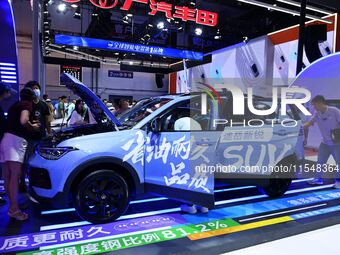 People look at various vehicles at the 23rd Autumn International Auto Show in Qingdao, China, on September 5, 2024. (