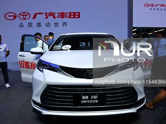 People look at various vehicles at the 23rd Autumn International Auto Show in Qingdao, China, on September 5, 2024. (