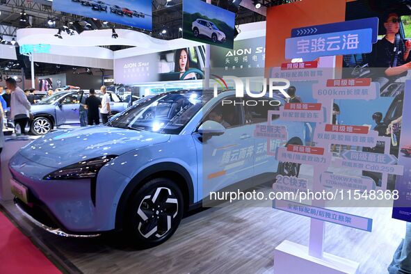 People look at various vehicles at the 23rd Autumn International Auto Show in Qingdao, China, on September 5, 2024. 