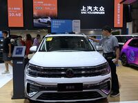 People look at various vehicles at the 23rd Autumn International Auto Show in Qingdao, China, on September 5, 2024. (