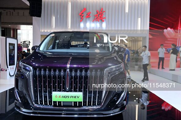 People look at various vehicles at the 23rd Autumn International Auto Show in Qingdao, China, on September 5, 2024. 