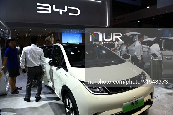 People look at various vehicles at the 23rd Autumn International Auto Show in Qingdao, China, on September 5, 2024. 