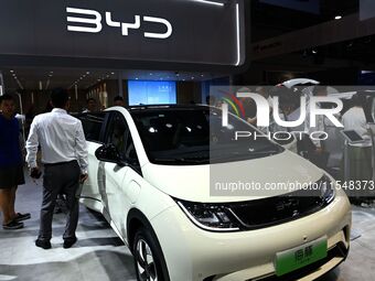 People look at various vehicles at the 23rd Autumn International Auto Show in Qingdao, China, on September 5, 2024. (