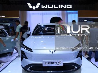 People look at various vehicles at the 23rd Autumn International Auto Show in Qingdao, China, on September 5, 2024. (