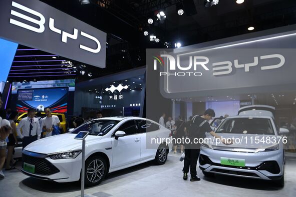 People look at various vehicles at the 23rd Autumn International Auto Show in Qingdao, China, on September 5, 2024. 