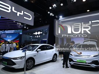 People look at various vehicles at the 23rd Autumn International Auto Show in Qingdao, China, on September 5, 2024. (