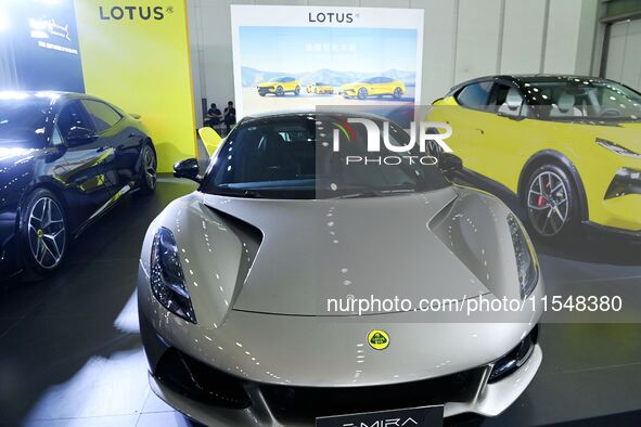 People look at various vehicles at the 23rd Autumn International Auto Show in Qingdao, China, on September 5, 2024. 