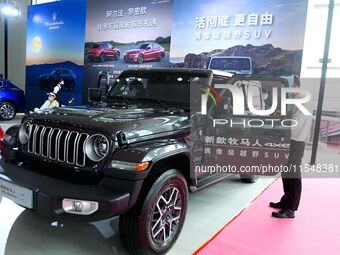 People look at various vehicles at the 23rd Autumn International Auto Show in Qingdao, China, on September 5, 2024. (