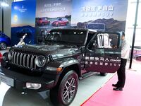 People look at various vehicles at the 23rd Autumn International Auto Show in Qingdao, China, on September 5, 2024. (