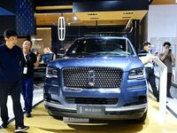 People look at various vehicles at the 23rd Autumn International Auto Show in Qingdao, China, on September 5, 2024. (