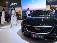 People look at various vehicles at the 23rd Autumn International Auto Show in Qingdao, China, on September 5, 2024. (