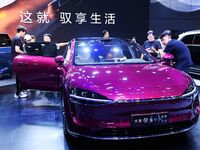 People look at various vehicles at the 23rd Autumn International Auto Show in Qingdao, China, on September 5, 2024. (