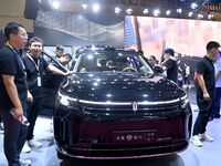 People look at various vehicles at the 23rd Autumn International Auto Show in Qingdao, China, on September 5, 2024. (