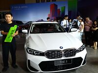 People look at various vehicles at the 23rd Autumn International Auto Show in Qingdao, China, on September 5, 2024. (