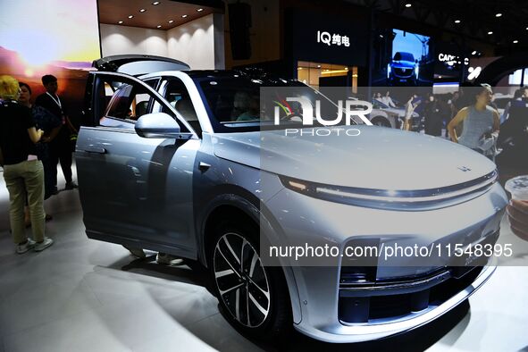 People look at various vehicles at the 23rd Autumn International Auto Show in Qingdao, China, on September 5, 2024. 