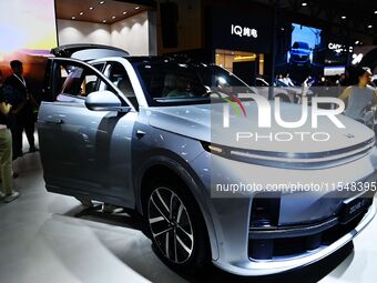 People look at various vehicles at the 23rd Autumn International Auto Show in Qingdao, China, on September 5, 2024. (