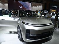 People look at various vehicles at the 23rd Autumn International Auto Show in Qingdao, China, on September 5, 2024. (