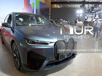 People look at various vehicles at the 23rd Autumn International Auto Show in Qingdao, China, on September 5, 2024. (