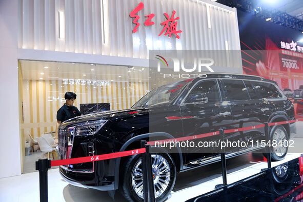 People look at various vehicles at the 23rd Autumn International Auto Show in Qingdao, China, on September 5, 2024. 