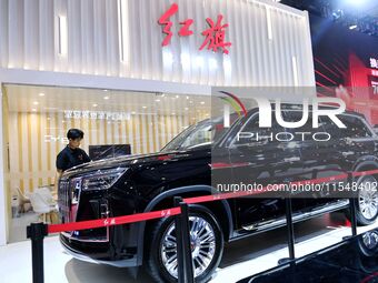 People look at various vehicles at the 23rd Autumn International Auto Show in Qingdao, China, on September 5, 2024. (