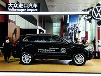 People look at various vehicles at the 23rd Autumn International Auto Show in Qingdao, China, on September 5, 2024. (