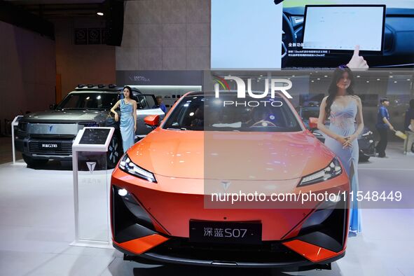 A model displays a new car at the 23rd Autumn International Auto Show in Qingdao, China, on September 5, 2024. 