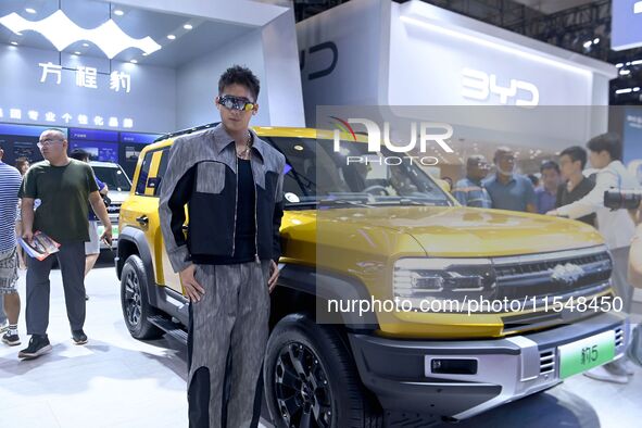 A model displays a new car at the 23rd Autumn International Auto Show in Qingdao, China, on September 5, 2024. 