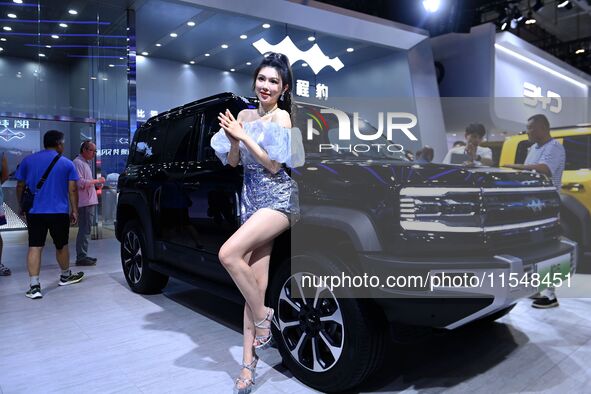 A model displays a new car at the 23rd Autumn International Auto Show in Qingdao, China, on September 5, 2024. 