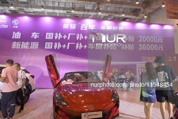 Promotional information about replacement vehicles is seen at the 23rd Autumn International Auto Show 2024 in Qingdao, China, on September 5...