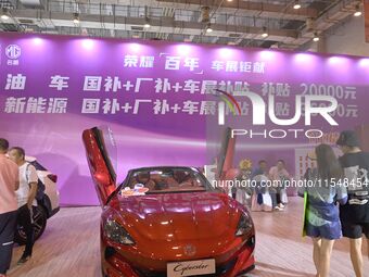 Promotional information about replacement vehicles is seen at the 23rd Autumn International Auto Show 2024 in Qingdao, China, on September 5...