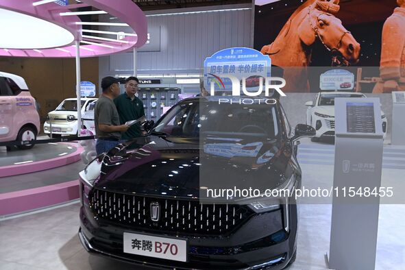 Promotional information about replacement vehicles is seen at the 23rd Autumn International Auto Show 2024 in Qingdao, China, on September 5...