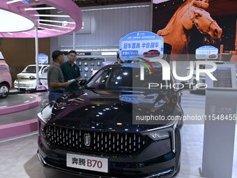 Promotional information about replacement vehicles is seen at the 23rd Autumn International Auto Show 2024 in Qingdao, China, on September 5...