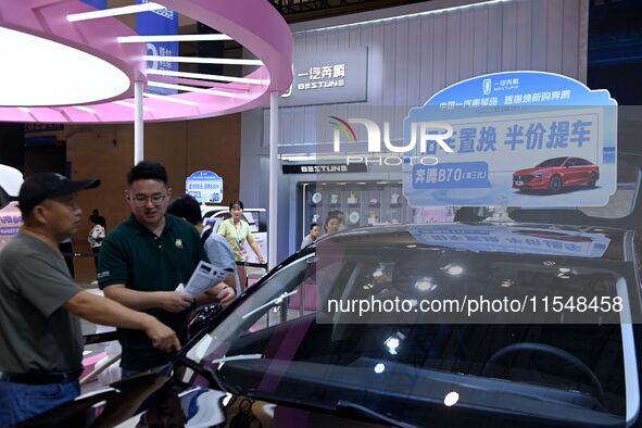 Promotional information about replacement vehicles is seen at the 23rd Autumn International Auto Show 2024 in Qingdao, China, on September 5...