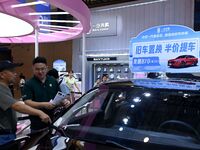 Promotional information about replacement vehicles is seen at the 23rd Autumn International Auto Show 2024 in Qingdao, China, on September 5...