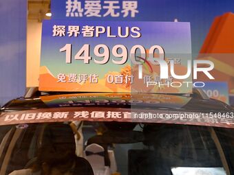 Promotional information about replacement vehicles is seen at the 23rd Autumn International Auto Show 2024 in Qingdao, China, on September 5...