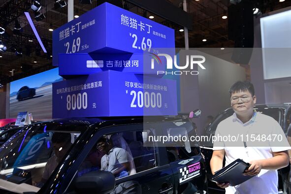 Promotional information about replacement vehicles is seen at the 23rd Autumn International Auto Show 2024 in Qingdao, China, on September 5...