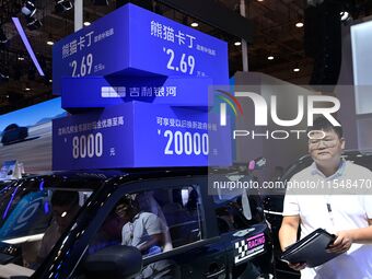 Promotional information about replacement vehicles is seen at the 23rd Autumn International Auto Show 2024 in Qingdao, China, on September 5...