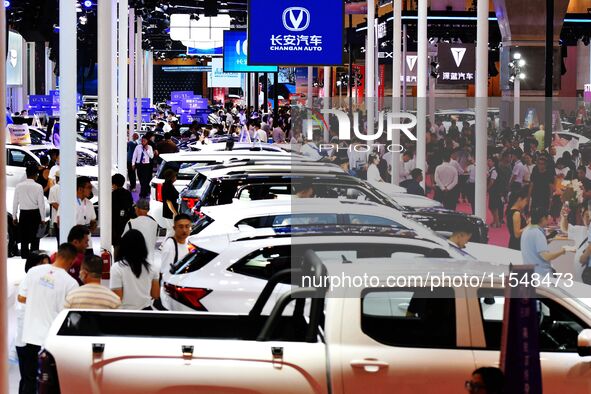 People look at various vehicles at the 23rd Autumn International Auto Show in Qingdao, China, on September 5, 2024. 