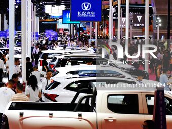 People look at various vehicles at the 23rd Autumn International Auto Show in Qingdao, China, on September 5, 2024. (