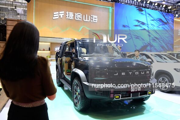 People look at various vehicles at the 23rd Autumn International Auto Show in Qingdao, China, on September 5, 2024. 