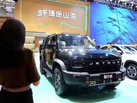 People look at various vehicles at the 23rd Autumn International Auto Show in Qingdao, China, on September 5, 2024. (